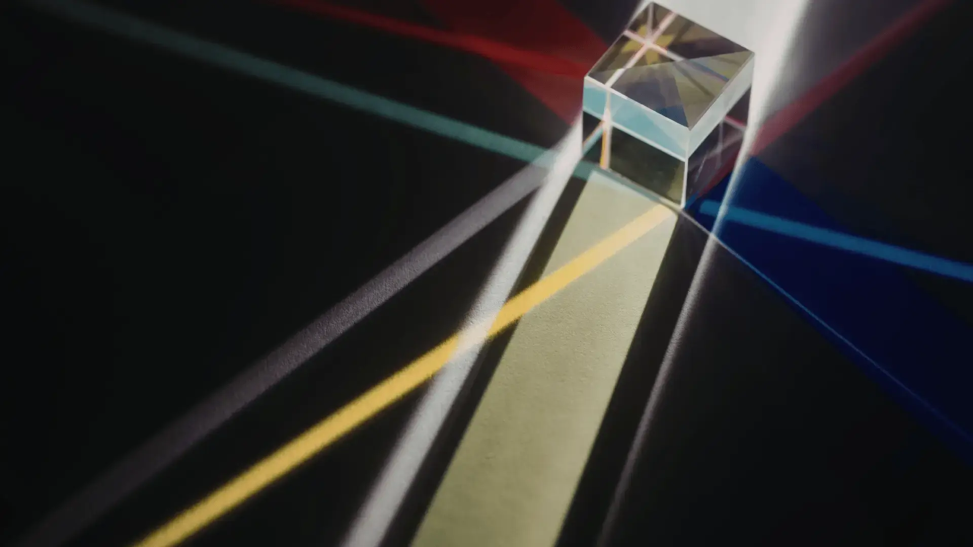 Glass prism refracting light into multiple colorful beams across a dark surface Trauma Therapist Institute